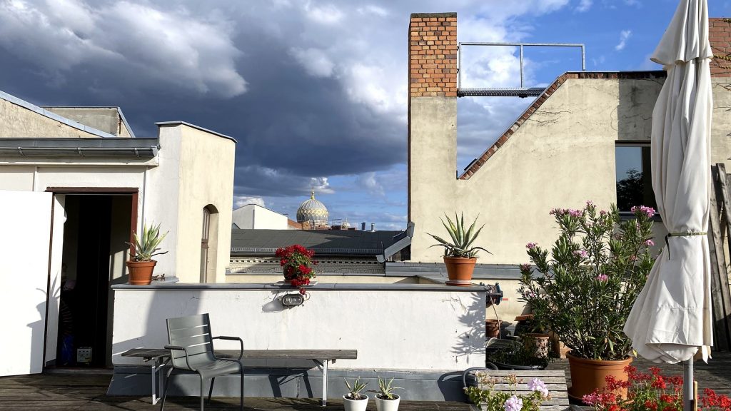 Blick von der Dachterrasse über die Dächer, im Hintergrund die goldene Kuppel der Neuen Synagoge.